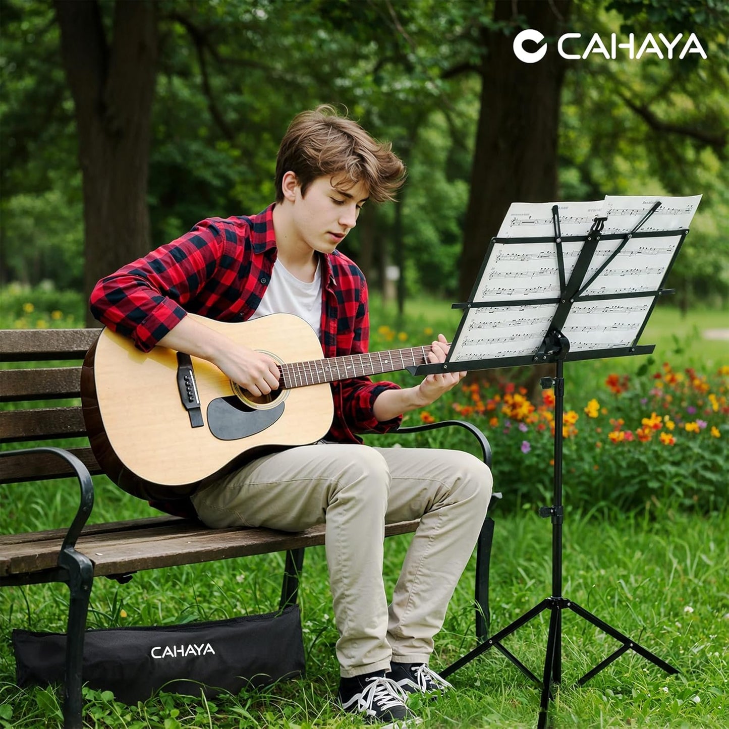 playing guitar with a music stand in a park